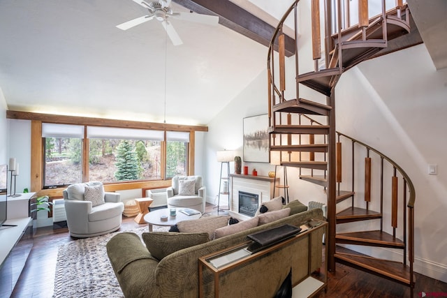 living area with dark wood-type flooring, stairs, and high vaulted ceiling