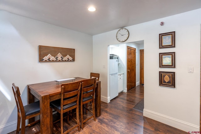 dining room featuring recessed lighting, baseboards, and dark wood finished floors