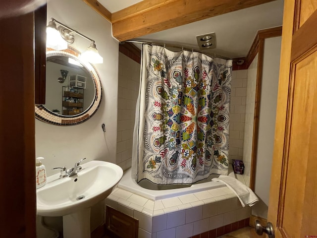 bathroom with a sink and tiled shower / bath combo