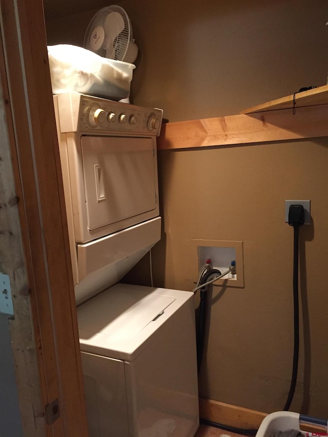 washroom featuring laundry area and stacked washer / drying machine