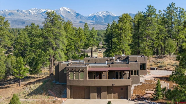 exterior space featuring a wooded view