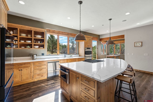 kitchen featuring a kitchen island, recessed lighting, a sink, dark wood finished floors, and appliances with stainless steel finishes