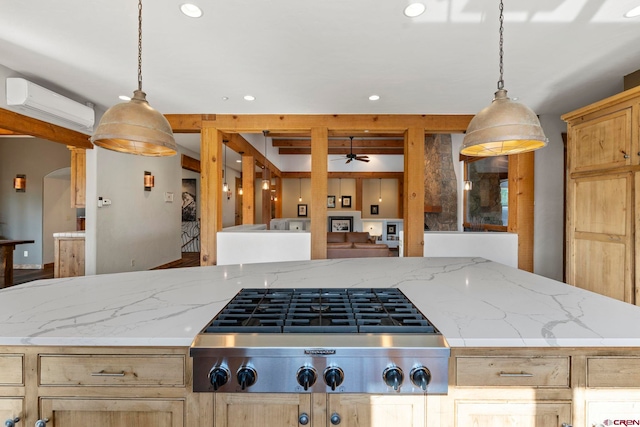 kitchen with a ceiling fan, a wall mounted air conditioner, stainless steel gas cooktop, and recessed lighting