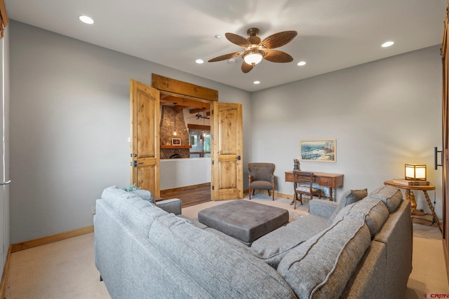 living area featuring recessed lighting, baseboards, ceiling fan, and light carpet