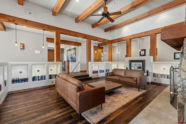 living area featuring dark wood-style flooring, beamed ceiling, and ceiling fan