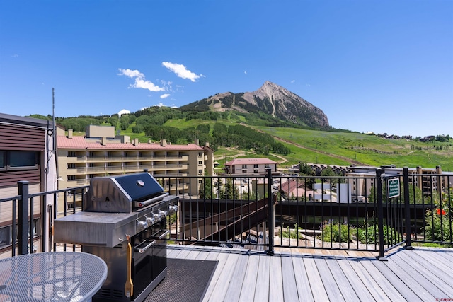 40 Marcellina Ln Unit 16, Mount Crested Butte, CO 81225 - wooden terrace with a mountain view and a grill