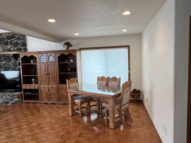 dining area with recessed lighting and a textured ceiling
