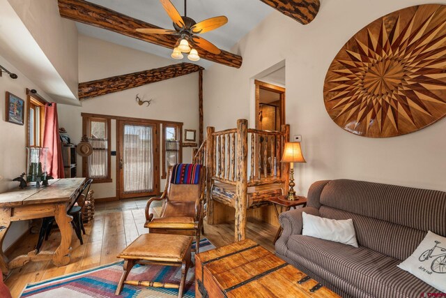 living area with wood-type flooring, ceiling fan, beam ceiling, and high vaulted ceiling