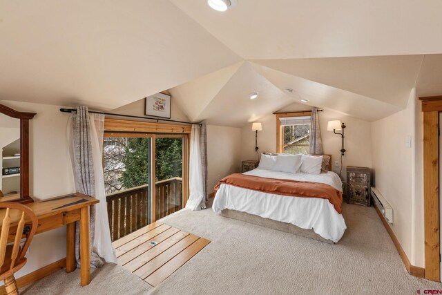 bedroom with carpet floors, a baseboard heating unit, and multiple windows