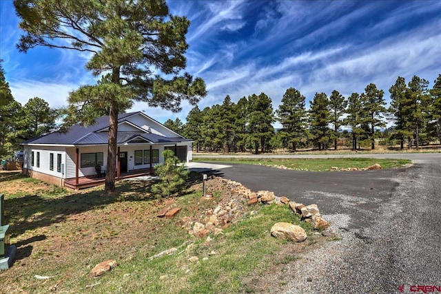 474 Lakewood St, Pagosa Springs, CO 81147 - view of front of home featuring aphalt driveway, covered porch, and metal roof