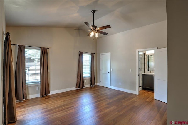 474 Lakewood St, Pagosa Springs, CO 81147 - unfurnished bedroom with ceiling fan, high vaulted ceiling, dark wood finished floors, baseboards, and ensuite bathroom