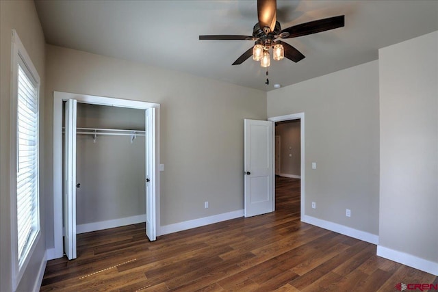 474 Lakewood St, Pagosa Springs, CO 81147 - unfurnished bedroom featuring baseboards, dark wood finished floors, ceiling fan, and a closet