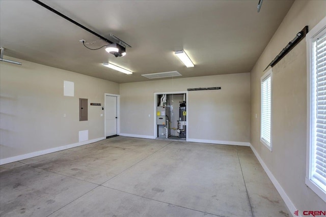 474 Lakewood St, Pagosa Springs, CO 81147 - garage featuring baseboards, a garage door opener, and electric panel