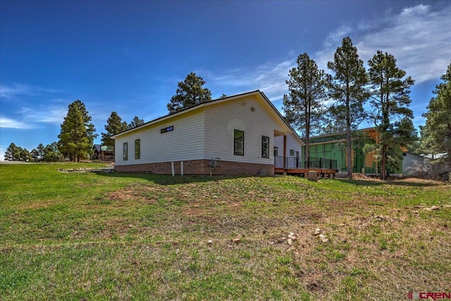 474 Lakewood St, Pagosa Springs, CO 81147 - view of property exterior featuring a lawn and a wooden deck