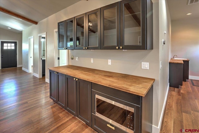 474 Lakewood St, Pagosa Springs, CO 81147 - bar with stainless steel microwave, dark wood-style flooring, baseboards, and vaulted ceiling with beams