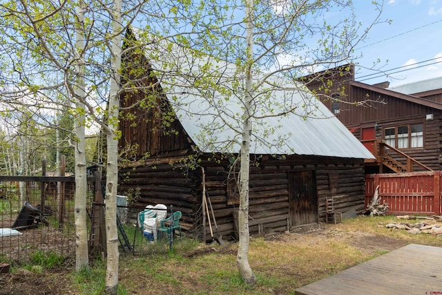 413 Second St, Crested Butte, CO 81224 - view of side of property with metal roof, fence, log siding, and an outdoor structure