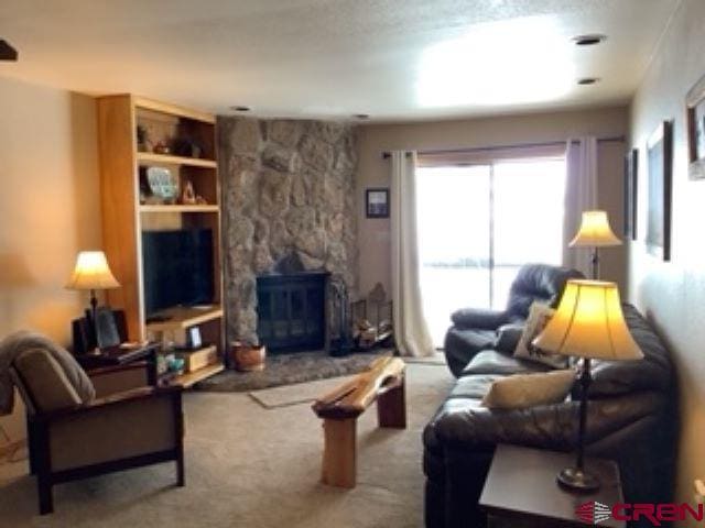 living area with carpet flooring and a fireplace