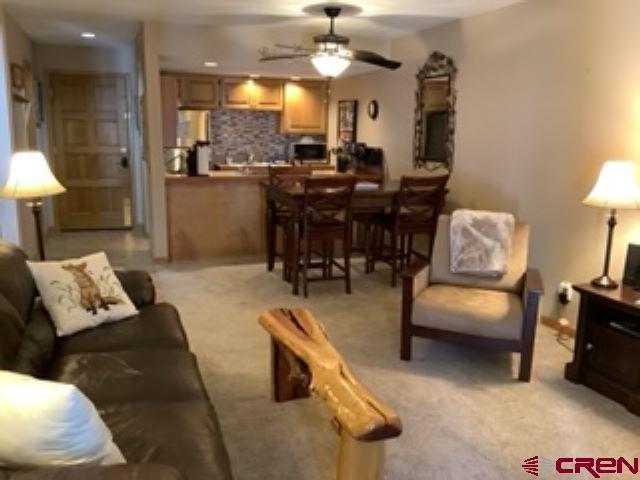50827 N 550th Hwy Unit 306, Durango, CO 81301 - living room with ceiling fan and light colored carpet