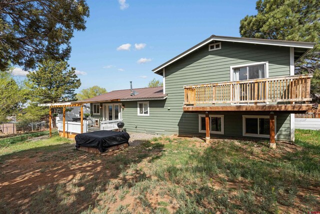 826 E Tamarack Dr, Bayfield, CO 81122 - rear view of property featuring a hot tub, a deck, and metal roof