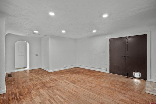 319 Rosevale Rd, Grand Junction, CO 81507 - unfurnished room featuring arched walkways, recessed lighting, baseboards, wood finished floors, and visible vents