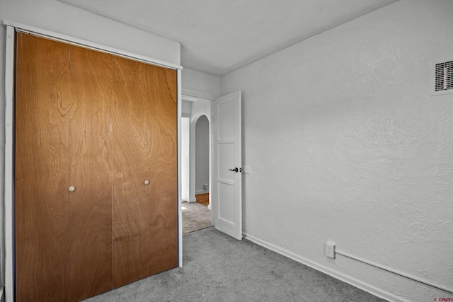 319 Rosevale Rd, Grand Junction, CO 81507 - unfurnished bedroom with carpet floors, arched walkways, baseboards, and a closet