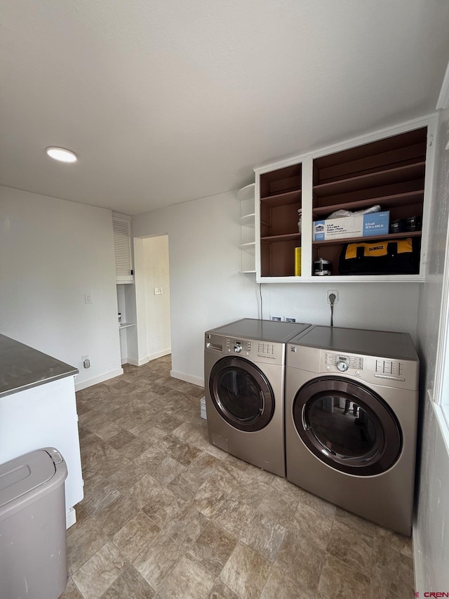 319 Rosevale Rd, Grand Junction, CO 81507 - washroom with washing machine and clothes dryer, laundry area, stone finish floor, and baseboards
