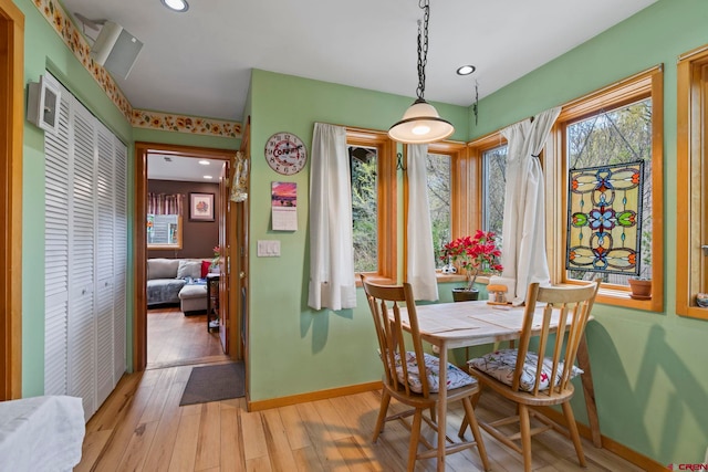 dining room with recessed lighting, baseboards, and light wood-type flooring