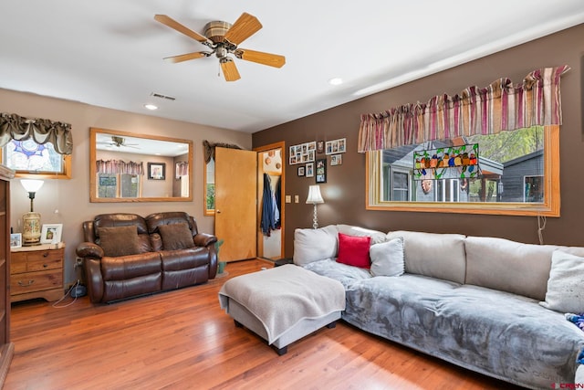 living area with visible vents, wood finished floors, a healthy amount of sunlight, ceiling fan, and recessed lighting