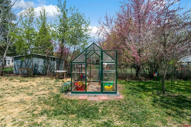 view of greenhouse featuring a lawn