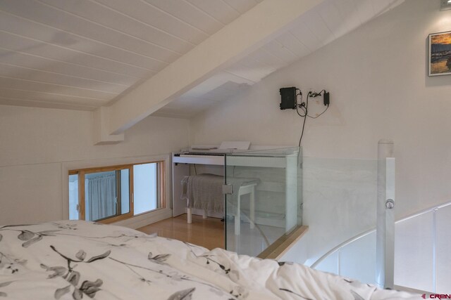 bedroom with vaulted ceiling with beams