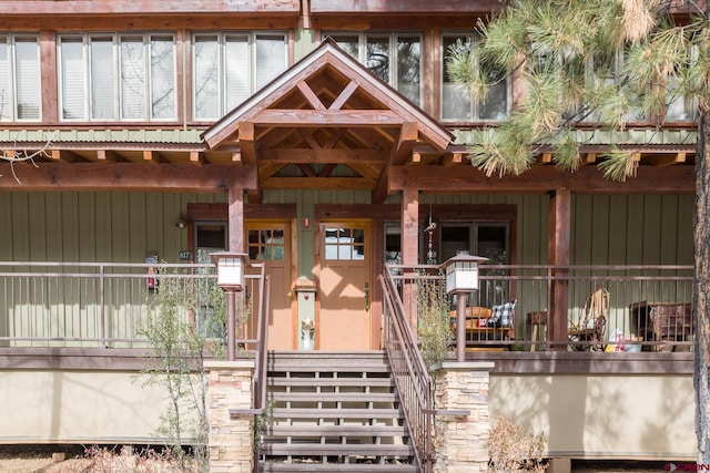 view of exterior entry featuring a porch