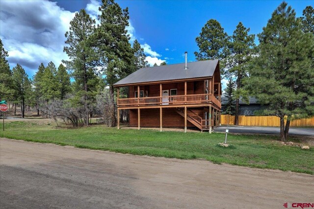 back of property featuring stairway, a yard, fence, and a wooden deck