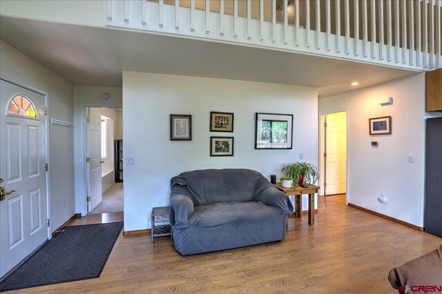 sitting room featuring baseboards, recessed lighting, and wood finished floors