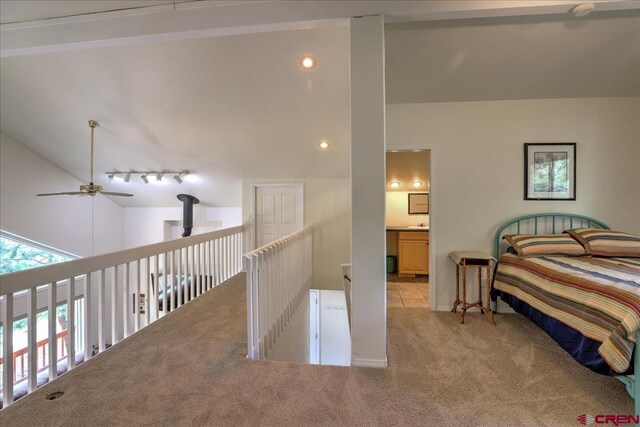 bedroom featuring lofted ceiling and light colored carpet