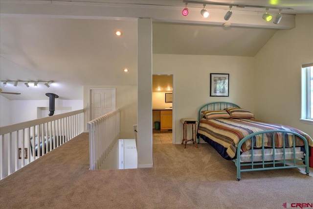 bedroom with carpet floors, vaulted ceiling, and rail lighting