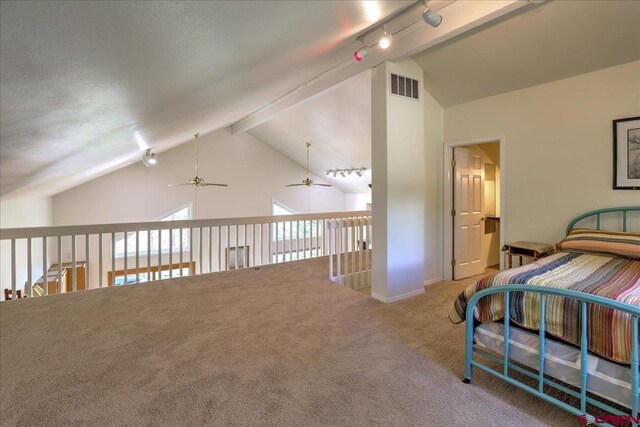 bedroom featuring carpet flooring, lofted ceiling with beams, track lighting, and visible vents