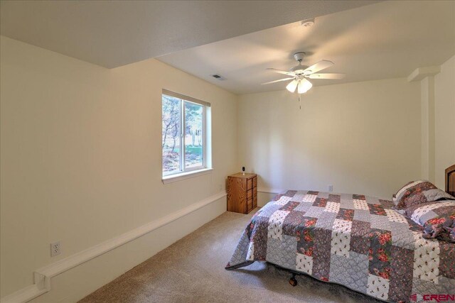 bedroom with carpet flooring, ceiling fan, and visible vents