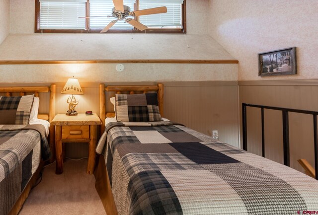 bedroom featuring carpet and wainscoting