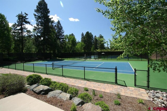 view of tennis court featuring fence