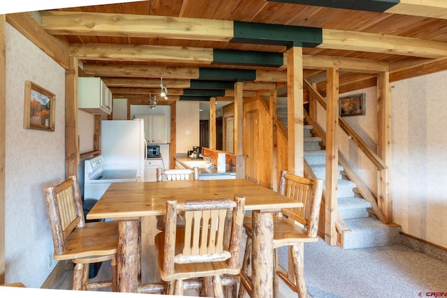dining room with stairs, beamed ceiling, wallpapered walls, and wood ceiling