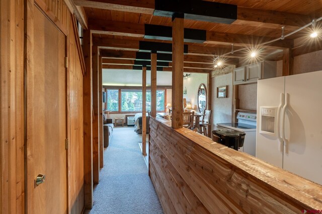 interior space featuring carpet flooring and beamed ceiling