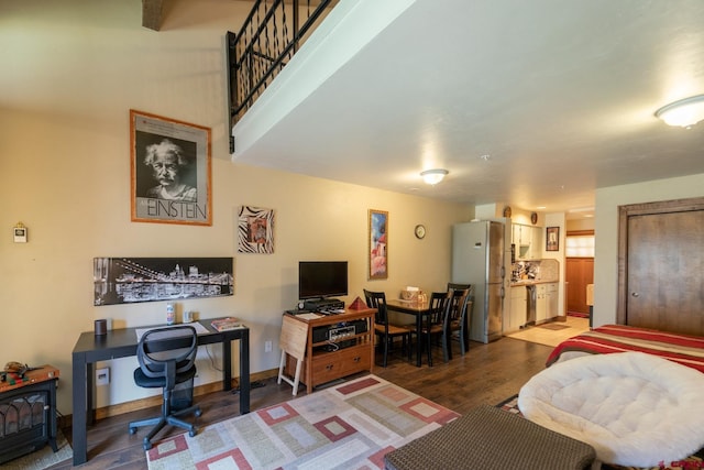 living area featuring a wood stove and wood finished floors
