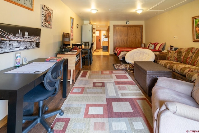 living room featuring attic access and wood finished floors