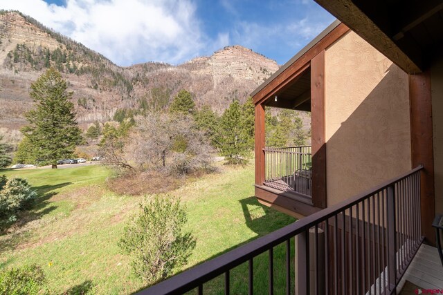 view of yard with a mountain view and a balcony