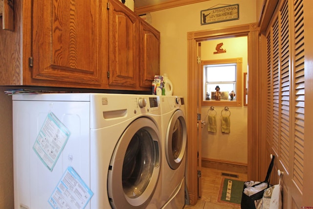 laundry area with cabinet space, visible vents, and washing machine and clothes dryer