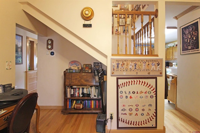 interior space featuring baseboards and wood finished floors