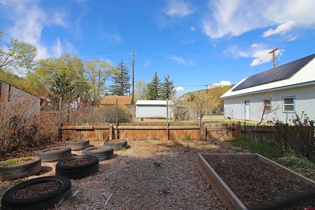 view of yard with a fenced backyard and a garden