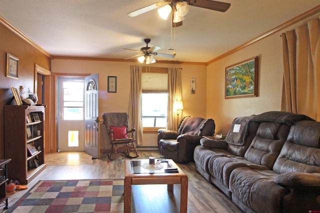 living room with a ceiling fan, wood finished floors, and a wealth of natural light
