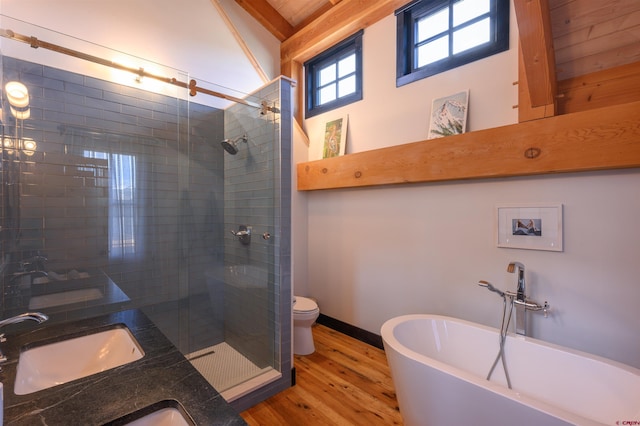 96 Chestnut Ln, Crested Butte, CO 81224 - full bath featuring a stall shower, wood finished floors, a sink, toilet, and a soaking tub