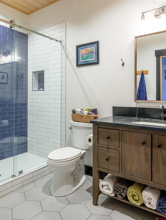 bathroom featuring vanity, a stall shower, and toilet